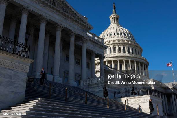 Capitol Police officers stand at the base of the steps to the House Chambers as the House votes on a $1.7 trillion spending package on December 23,...