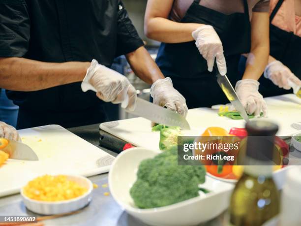 culinary students in a commercial kitchen - food and drink establishment stock pictures, royalty-free photos & images