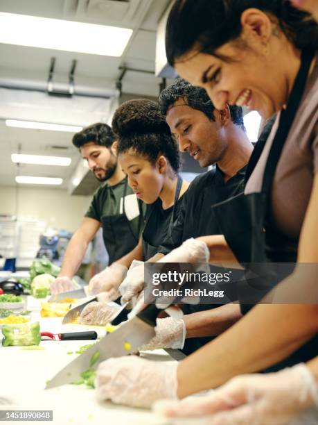 culinary students in a commercial kitchen - cooking class stockfoto's en -beelden