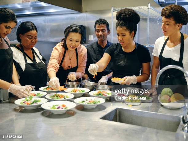 culinary students in a commercial kitchen - catering black uniform stock pictures, royalty-free photos & images