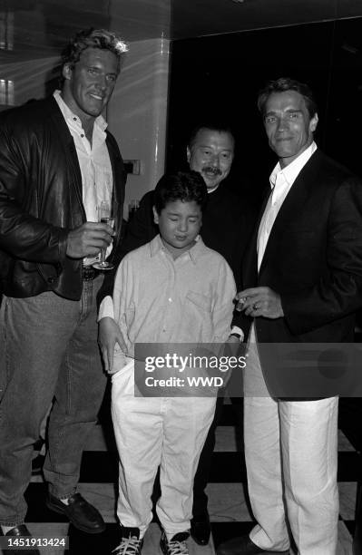 Michael Chow, Maximillian Chow, and actors Ralf Moeller and Arnold Schwarzenegger attend party celebrating Michael Chow's design of the new Giorgio...