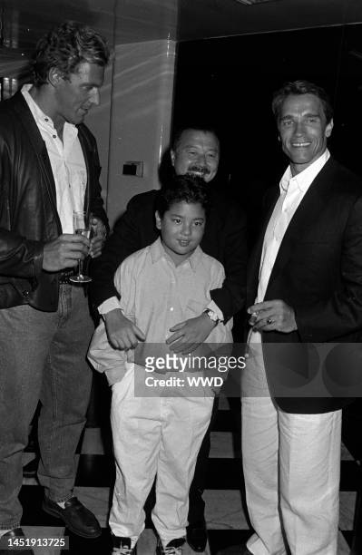 Michael Chow, Maximillian Chow, and actors Ralf Moeller and Arnold Schwarzenegger attend party celebrating Michael Chow's design of the new Giorgio...