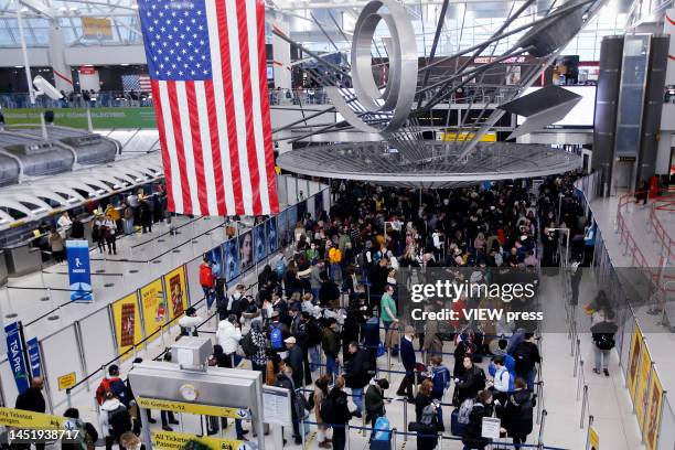 Travelers walk through JFK Airport on December 23, 2022 in New York City. Winter weather continues to disrupt holiday travel across the United...