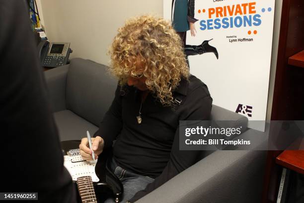 David Bryan signing memorbilia on a TV program on December 18, 2008 in New York City.