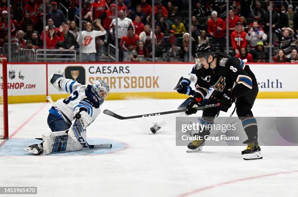 David Rittich of the Winnipeg Jets makes a save against Alex Ovechkin of the Washington Capitals in the second period at Capital One Arena on...