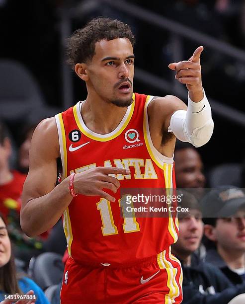 Trae Young of the Atlanta Hawks reacts after hitting a three-point basket against the Detroit Pistons during the first quarter at State Farm Arena on...