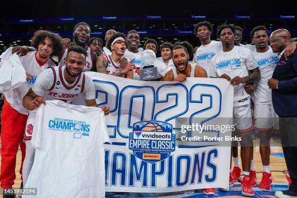St. John's Red Storm players with the banner after St. Johns defeated Syracuse in the championship game of the Empire Classic at Barclays Center in...