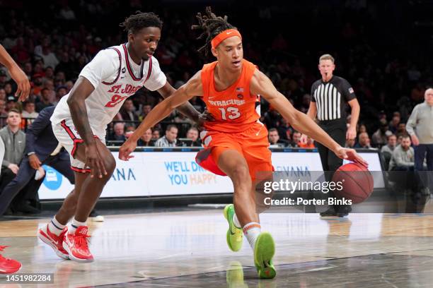 Benny Williams of the Syracuse Orange dribbles the ball against the St. John's Red Storm in the championship game of the Empire Classic at Barclays...