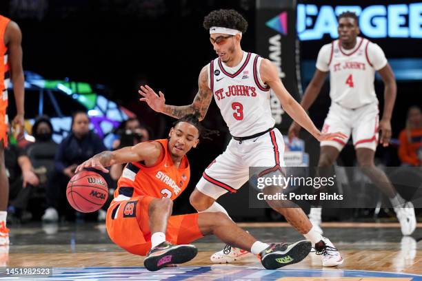 Judah Mintz of the Syracuse Orange tries to control the ball as he is guarded Andre Curbelo of the St. John's Red Storm in the championship game of...