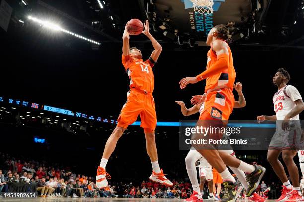 Jesse Edwards of the Syracuse Orange orbs a rebound against the St. John's Red Storm in the championship game of the Empire Classic at Barclays...