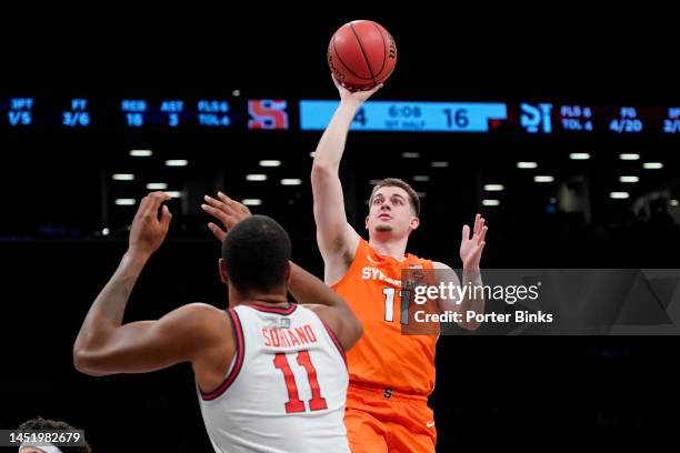 Joseph Girard III of the Syracuse Orange shoots the ball against the St. John's Red Storm in the championship game of the Empire Classic at Barclays...