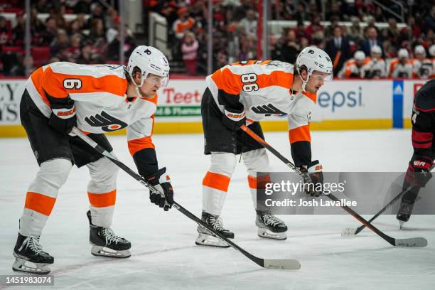 Travis Sanheim and Joel Farabee of the Philadelphia Flyers line up during the third period against the Carolina Hurricanes at PNC Arena on December...