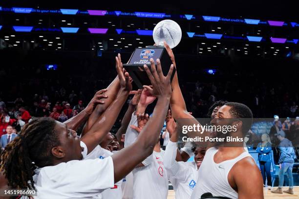 Joel Soriano of the St. John's Red Storm holds the championship trophy with O'Mar Stanley after St. Johns defeated Syracuse in the championship game...