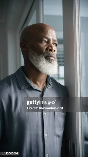 sad, thinking and depression with black man at window problem, lonely and lost crisis at home. anxiety, stress and mental health trauma with old man feeling burnout from drama, worry and failure - defeat fear stock pictures, royalty-free photos & images