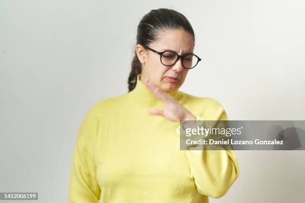 young woman feeling disgusted and complaining while standing an isolated background. - offensive stockfoto's en -beelden