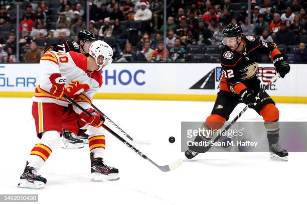 Jonathan Huberdeau of the Calgary Flames battles Kevin Shattenkirk of the Anaheim Ducks for a loose puck during the first period of a game at Honda...