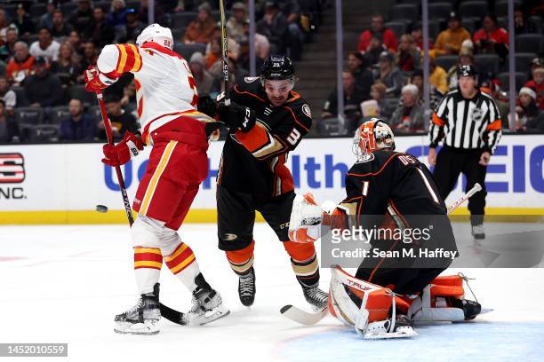 Trevor Lewis of the Calgary Flames attempts to tip a shot on goal as John Klingberg and Lukas Dostal of the Anaheim Ducks defend during the first...