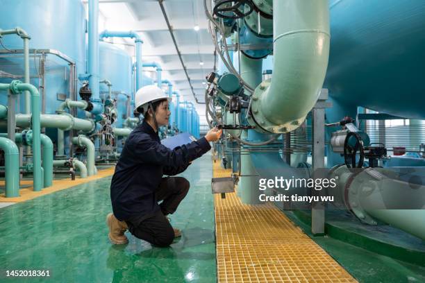 an asian female prosecutor works in the workshop of a chemical plant - pure power stock pictures, royalty-free photos & images