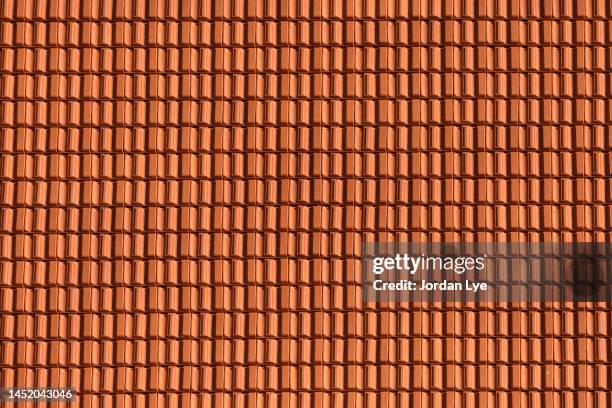 red clay roof tiles as a background - roof tile texture stock pictures, royalty-free photos & images