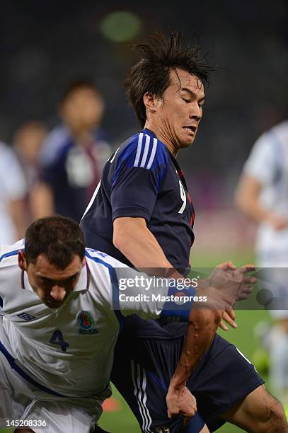 Shinji Okazaki of Japan and Mahir Shukurov of Azerbaijan compete for the ball during the international friendly match between Japan and Azerbaijan at...