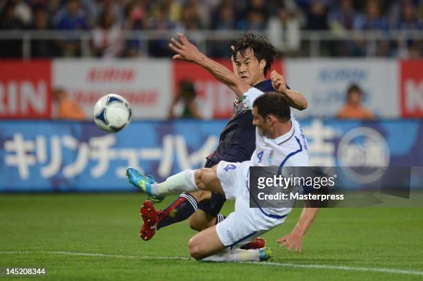 Shinji Okazaki of Japan and Mahir Shukurov of Azerbaijan compete for the ball during the international friendly match between Japan and Azerbaijan at...