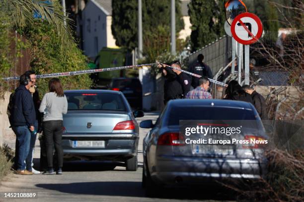 Policeman holds the seal in the vicinity of the house where a man has barricaded himself with a gun and was holding his sister, and wounded a GOES...