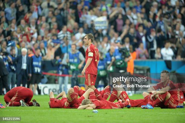 Bayern Munich captain Philipp Lahm stands amongst his dejected team-mates after losing the UEFA Champions League Final between FC Bayern Munich and...