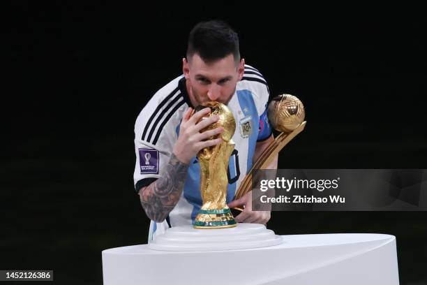 Lionel Messi of Argentina kisses The FIFA World Cup Qatar 2022 Winner's Trophy during the award ceremony of the FIFA World Cup Qatar 2022 Final match...