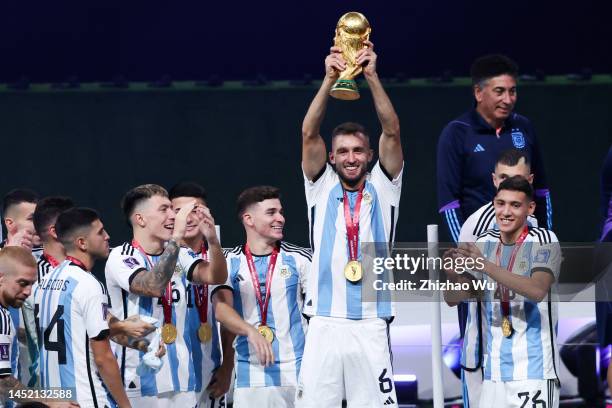 German Pezzella of Argentina rise up The FIFA World Cup Qatar 2022 Winner's Trophy and celebrates the champion with teammates during the award...