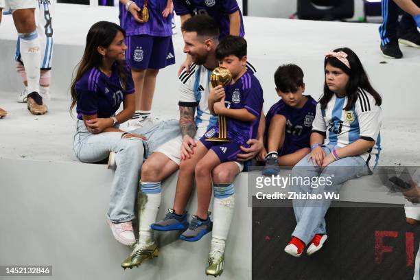 Lionel Messi of Argentina celebrates the champion with his family after the award ceremony of the FIFA World Cup Qatar 2022 Final match between...