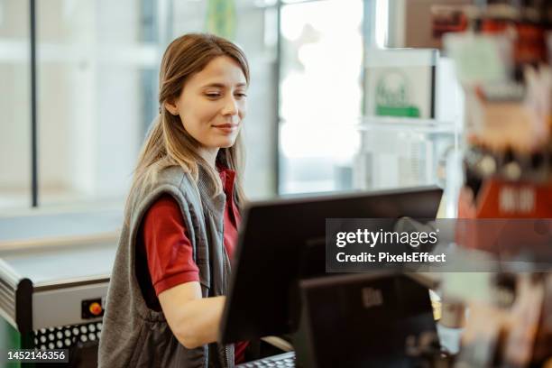 kassiererin arbeitet im supermarkt - markt verkaufsstätte stock-fotos und bilder