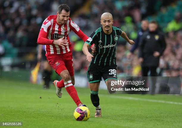 Ryan McGowan of St Johnstone vies with Daizen Maeda of Celtic during the Cinch Scottish Premiership match between Celtic FC and St. Johnstone FC at...