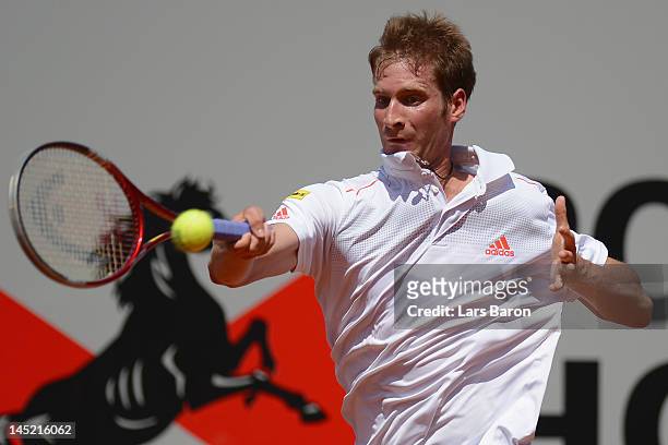 Florian Mayer of Germany plays a forehand during his match against Viktor Troicki of Serbia during day five of Power Horse World Team Cup at...