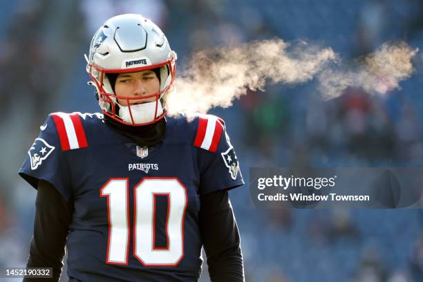 Mac Jones of the New England Patriots looks on during pregame against the Cincinnati Bengals at Gillette Stadium on December 24, 2022 in Foxborough,...