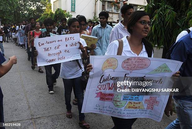 Social activists hold posters during a "Slut Walk" in Kolkata on May 24, 2012. Hundreds of supporters particiapted in the rally organised to protest...