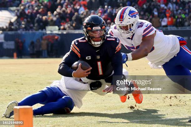 Justin Fields of the Chicago Bears is tackled by Greg Rousseau of the Buffalo Bills during the first quarter at Soldier Field on December 24, 2022 in...