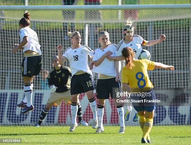 Wall of players of Germany jumps agasinst a kick taken by Loiuse Fors of Sweden during the U23's womens international friendly mtach between Germany...