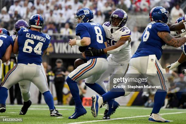 Daniel Jones of the New York Giants fumbles the ball after being hit by Danielle Hunter of the Minnesota Vikings during the first quarter at U.S....