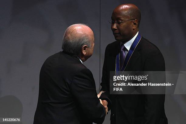 Eric Ekue receives the Order of Merit Award in the name of his father Godfried Foli Ekué from FIFA President Joseph S. Blatter during the Opening...