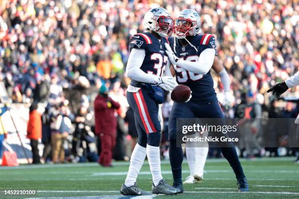 Devin McCourty of the New England Patriots celebrates with Anfernee Jennings of the New England Patriots after McCourty's interception during the...