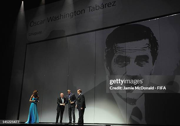 Oscar Washington Tabarez receives the Order of Merit Award from FIFA President Joseph S. Blatter during the 62nd FIFA Congress Opening Ceremony at...