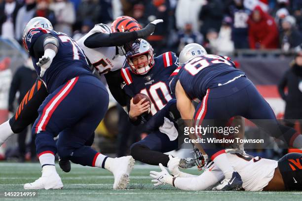 Cam Sample of the Cincinnati Bengals sacks Mac Jones of the New England Patriots during the second quarter at Gillette Stadium on December 24, 2022...