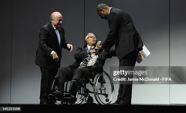 Winston Chung receives the Order of Merit Award from FIFA President Joseph Sepp Blatter and CONCACAF President Jeffrey Webb during the 62nd FIFA...