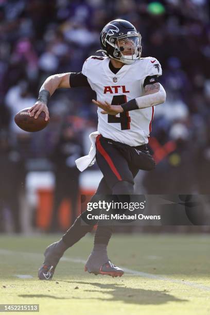 Desmond Ridder of the Atlanta Falcons scrambles and passes on the run during an NFL football game between the Baltimore Ravens and the Atlanta...