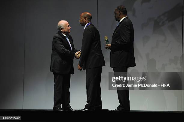 Eric Ekue receives the Order of Merit Award in the name of his father Godfried Foli Ekué from FIFA President Joseph Sepp Blatter during the 62nd FIFA...