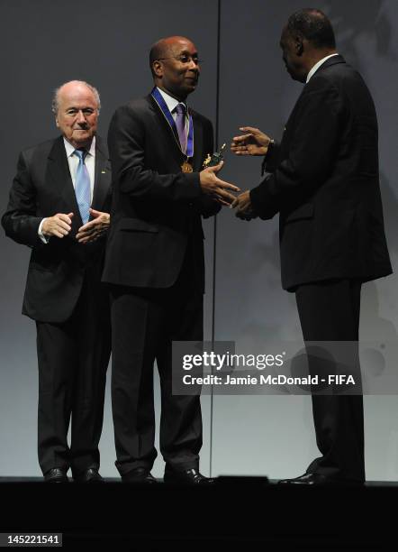 Eric Ekue receives the Order of Merit Award in the name of his father Godfried Foli Ekué from FIFA President Joseph Sepp Blatter during the 62nd FIFA...