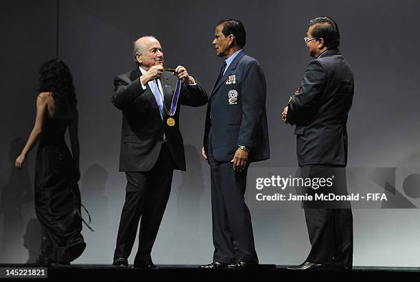 Hari Raij Naicker receives the Order of Merit Award from FIFA President Joseph Sepp Blatter during the 62nd FIFA Congress Opening Ceremony at the...