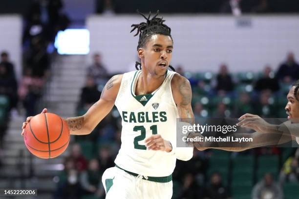 Emoni Bates of the Eastern Michigan Eagles dribbles the ball during a college basketball game against the Detroit Mercy Titans at the George Gervin...