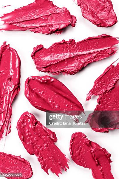 red, pink, viva magenta lipstick smears on white background, isolated. lip gloss samples are smudged. beauty cosmetic vertical pattern. makeup and skin care products. color of the year 2023. - pink lipstick smear stock pictures, royalty-free photos & images