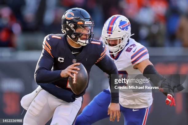 Justin Fields of the Chicago Bears avoids a tackle from AJ Epenesa of the Buffalo Bills during the fourth quarter at Soldier Field on December 24,...